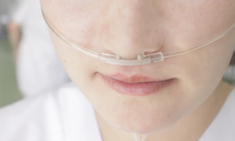 Breathing through a plastic nasal catheter during illness