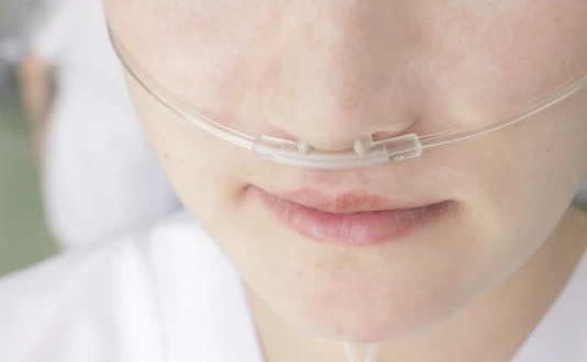 Breathing through a plastic nasal catheter during illness