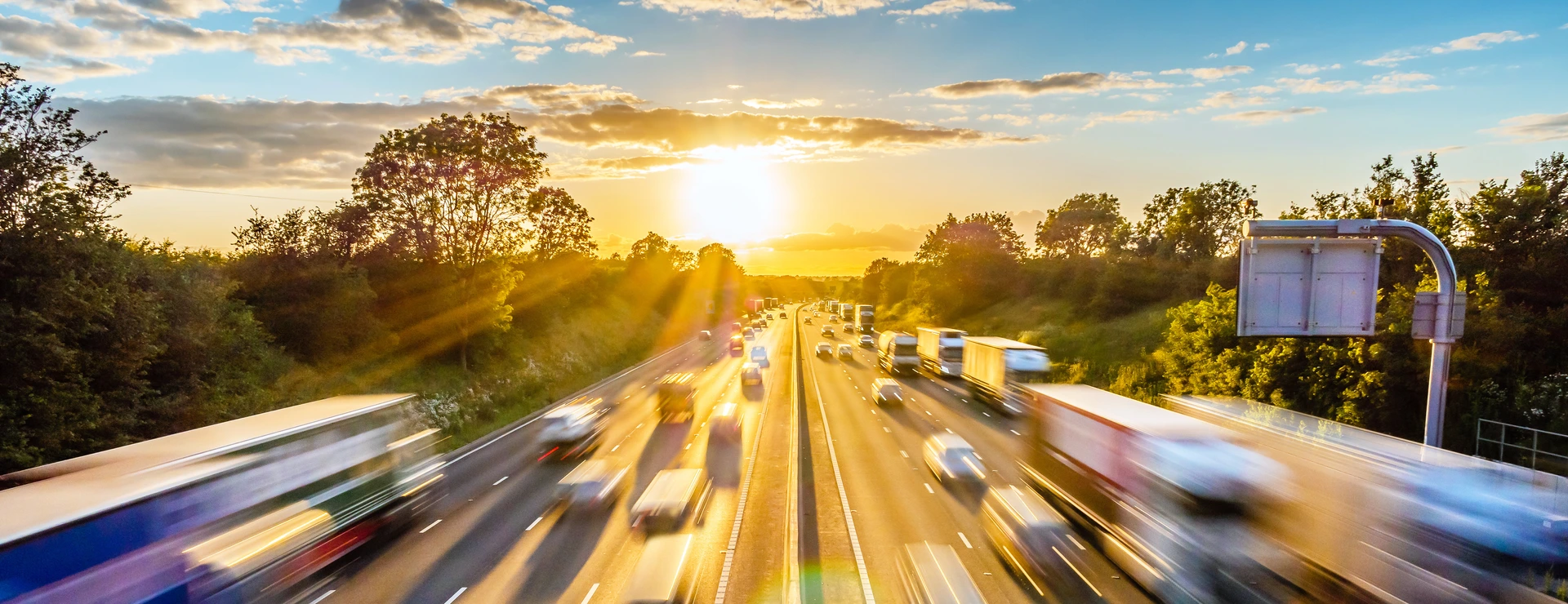 heavy traffic moving at speed on UK motorway in England at sunset