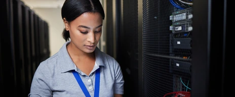 Woman, tablet and server room, programming or coding for cybersecurity, information technology or data protection backup. Engineering person on digital software, hardware inspection or basement check
