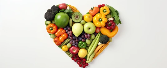 Fruits and vegetables arranged in the shape of a heart, representing healthy food and nutrition,