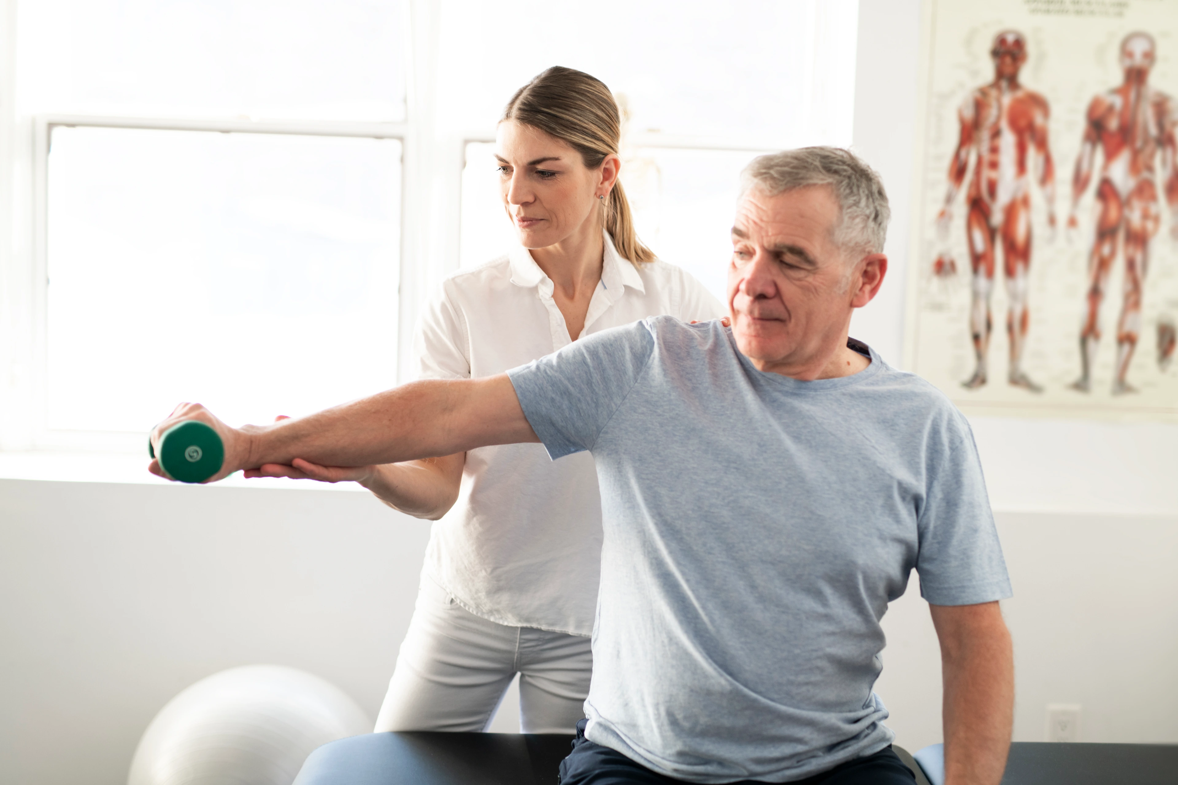 A Modern rehabilitation physiotherapy worker with senior client