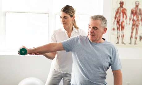 A Modern rehabilitation physiotherapy worker with senior client