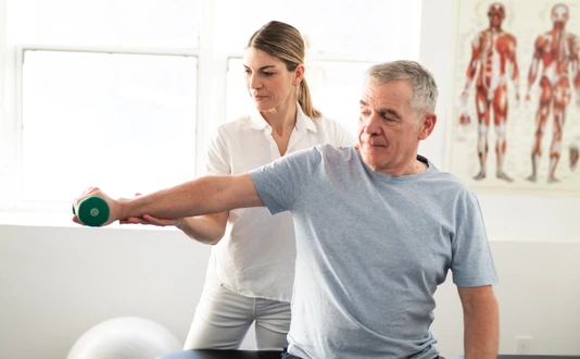 A Modern rehabilitation physiotherapy worker with senior client