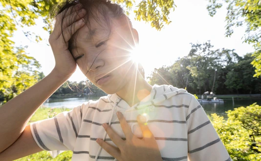 Tired asian woman suffer from sunburn very hot in summer weather problem feel faint,dizzy,difficulty breathing,female teenage with heat stroke,high temperature,burning heat wave hot sun on sunny day