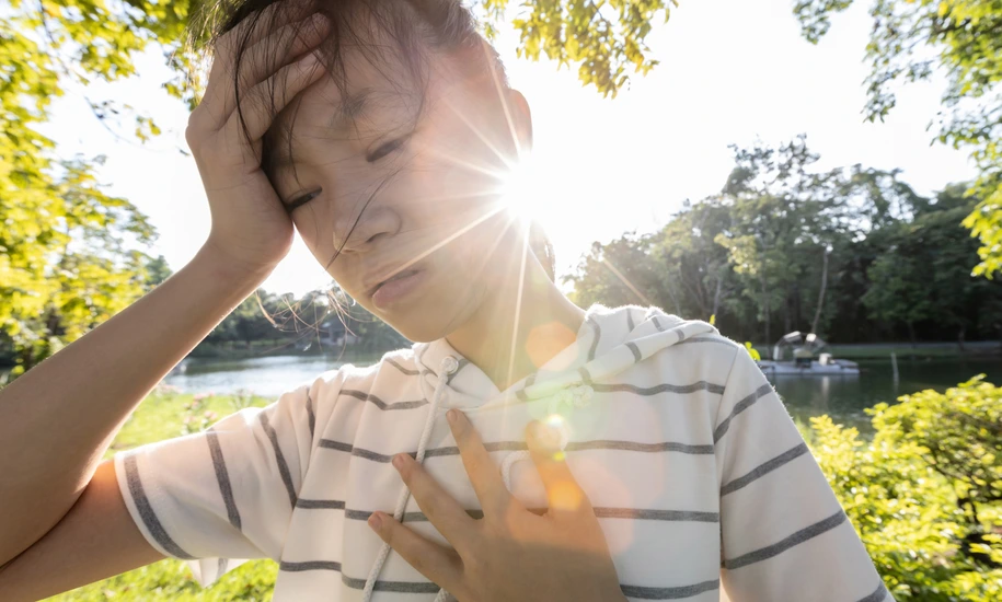 Tired asian woman suffer from sunburn very hot in summer weather problem feel faint,dizzy,difficulty breathing,female teenage with heat stroke,high temperature,burning heat wave hot sun on sunny day