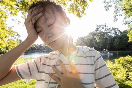 Tired asian woman suffer from sunburn very hot in summer weather problem feel faint,dizzy,difficulty breathing,female teenage with heat stroke,high temperature,burning heat wave hot sun on sunny day
