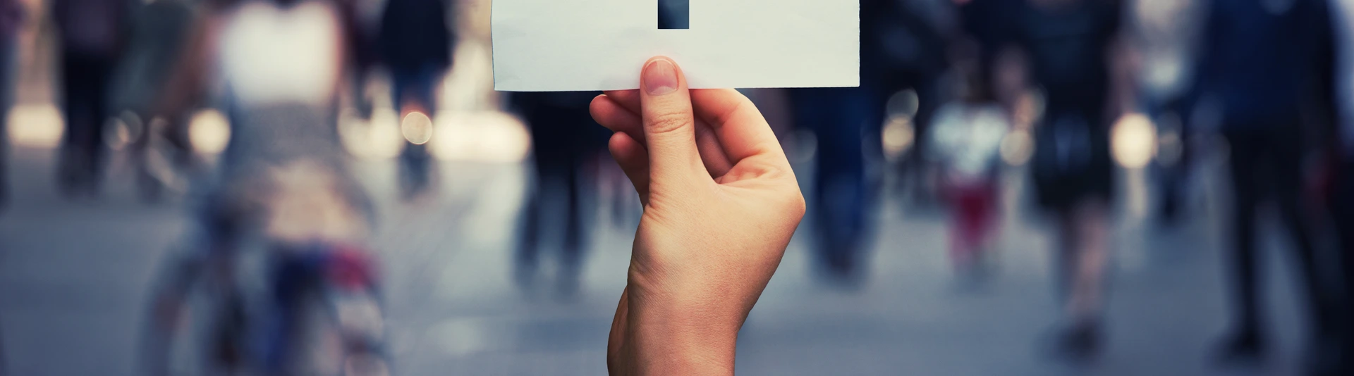 Hand holding a paper sheet with transgender symbol