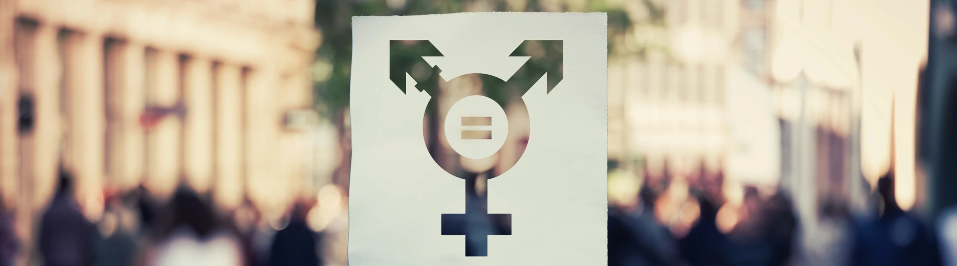 Hand holding a paper sheet with transgender symbol