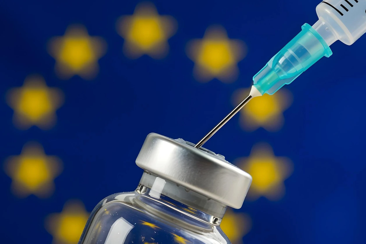 Syringe and vaccine bottle with the flag of the EU