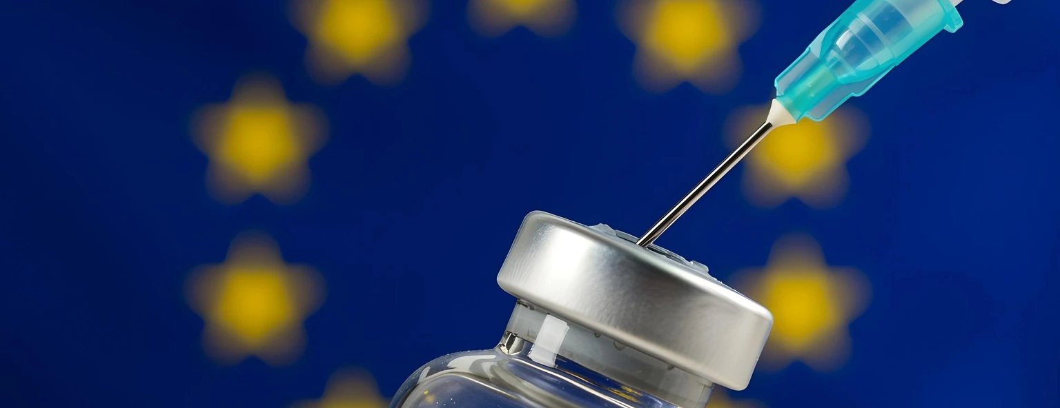 Syringe and vaccine bottle with the flag of the EU