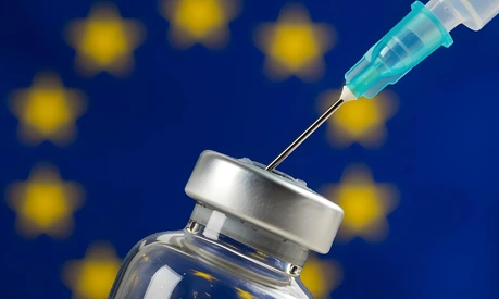 Syringe and vaccine bottle with the flag of the EU