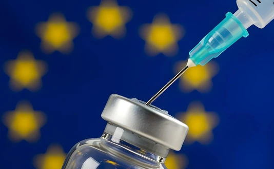 Syringe and vaccine bottle with the flag of the EU