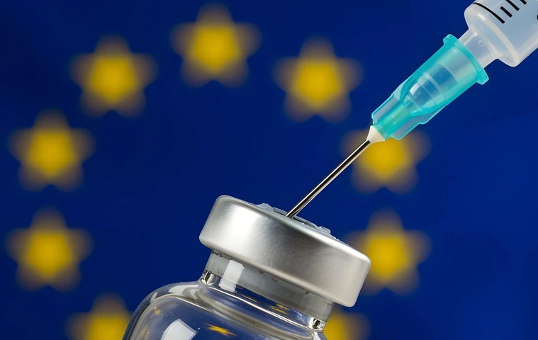 Syringe and vaccine bottle with the flag of the EU