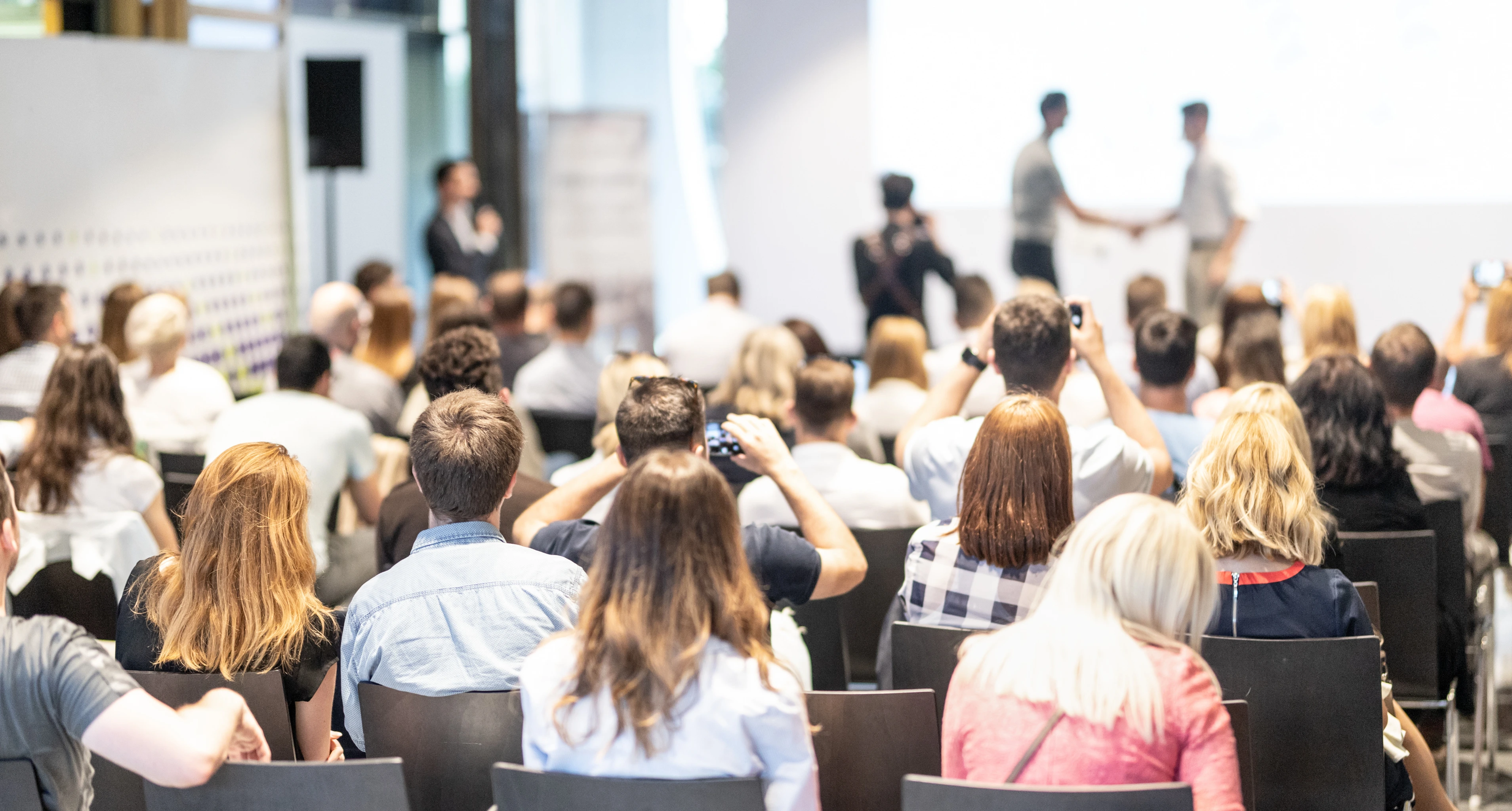 Businessmen shaking hands to seal a deal with his partner. Business and entrepreneurship award ceremony theme.