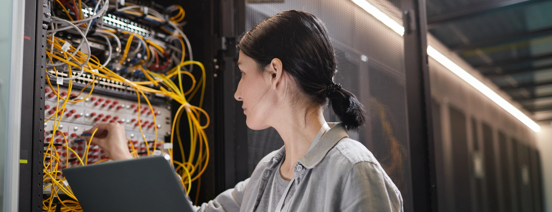 Female Network Technician Connecting Cables