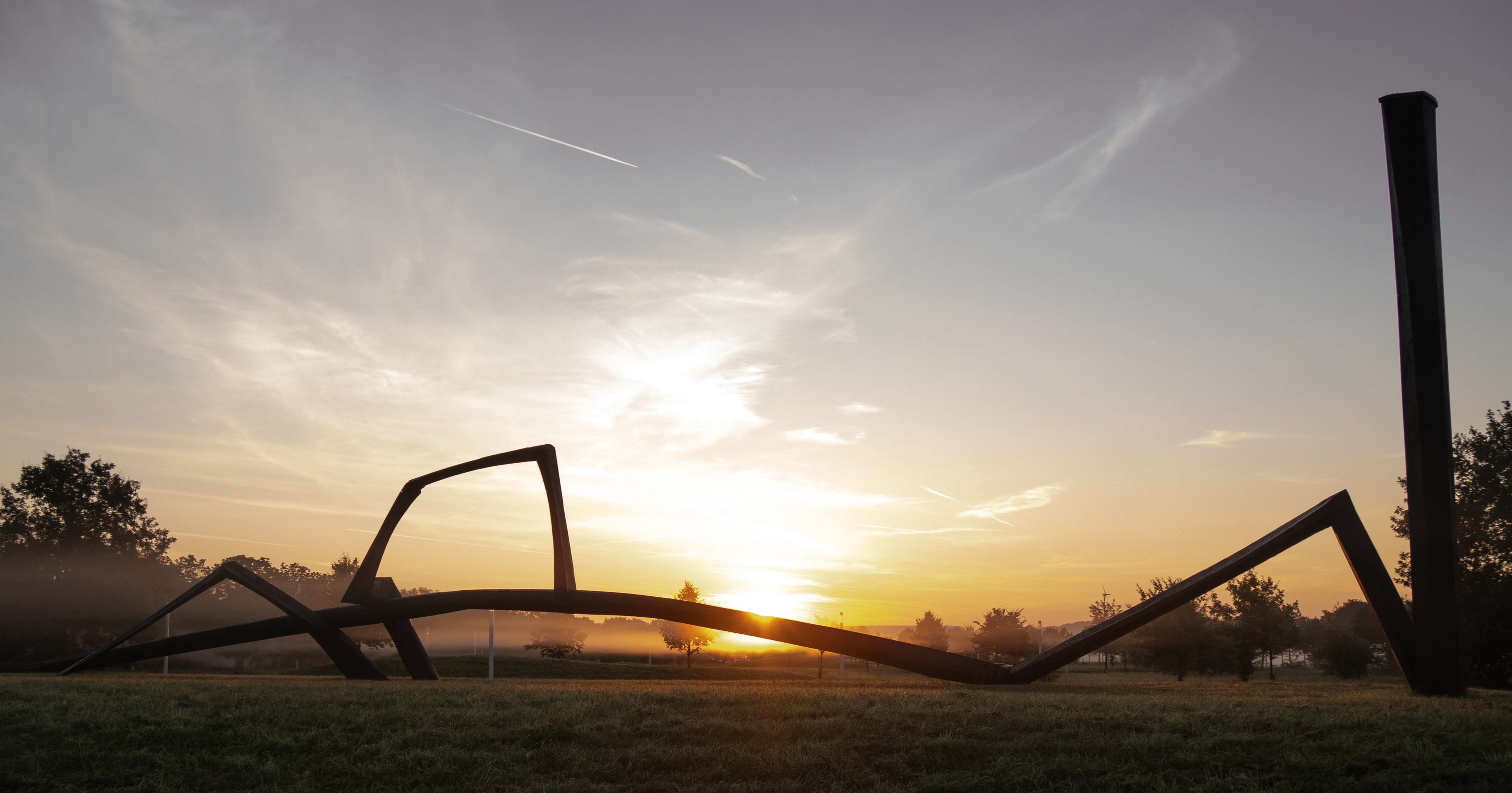 Helmholtz Munich Campus - Sculpture in front of sunrise