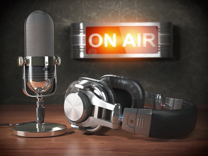 Vintage microphone  and headphones with signboard on air