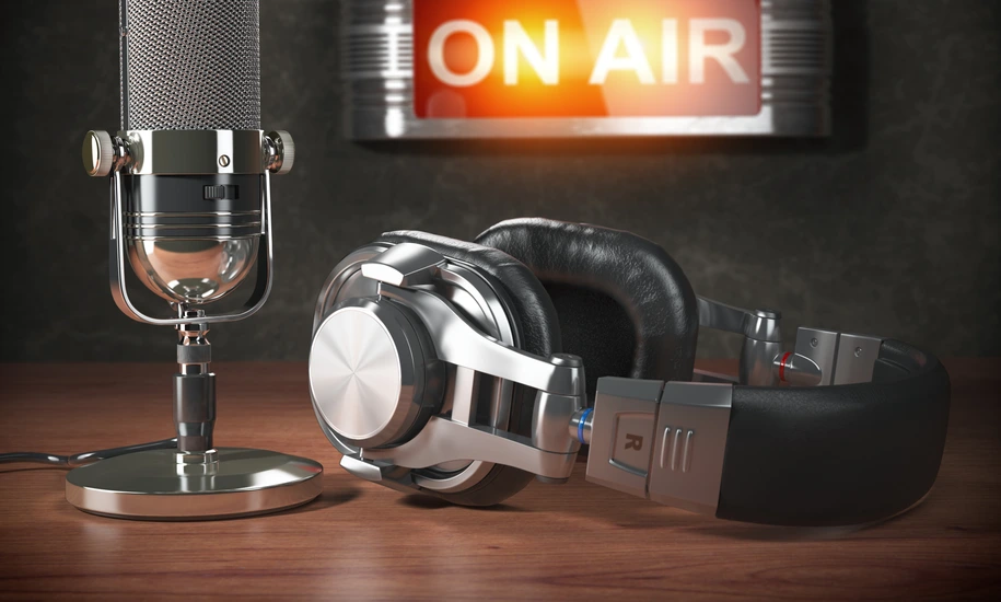 Vintage microphone  and headphones with signboard on air