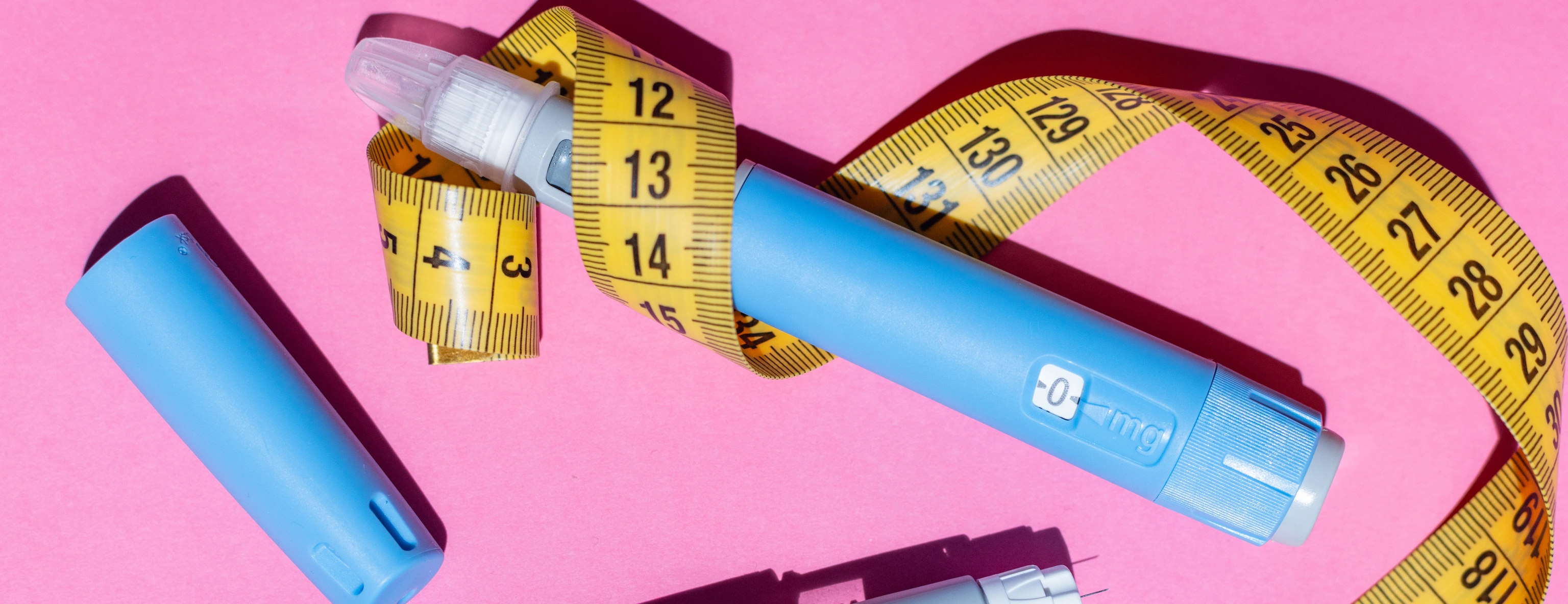 Ozempic pens and measurement tape.