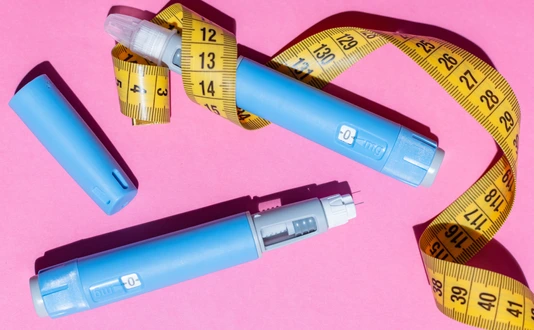 Ozempic pens and measurement tape.