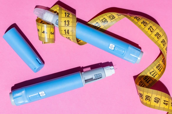 Ozempic pens and measurement tape.