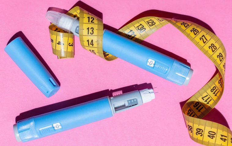 Ozempic pens and measurement tape.