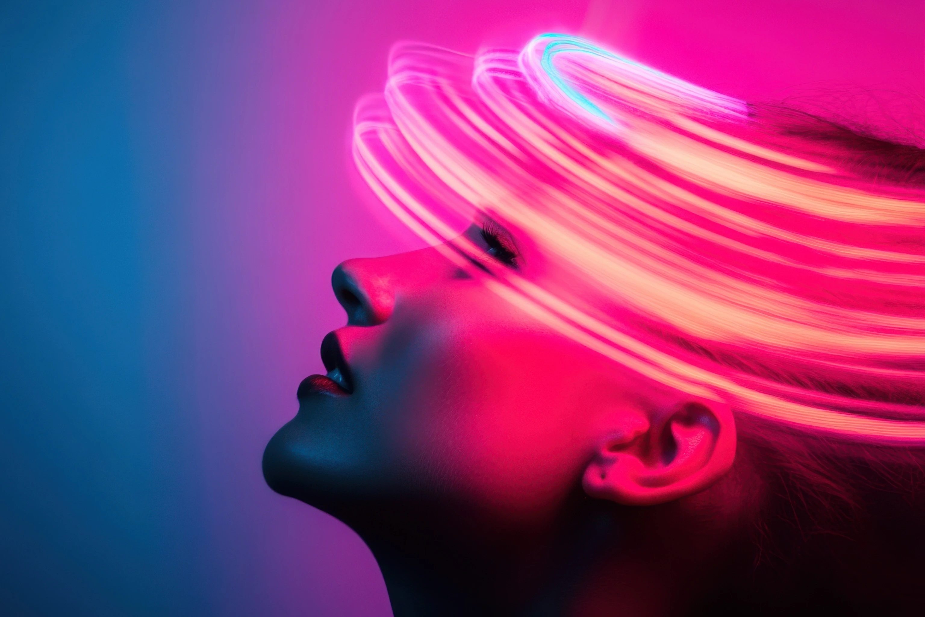 Woman posing under neon lights with blue and purple background