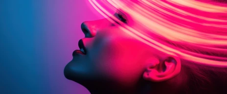 Woman posing under neon lights with blue and purple background