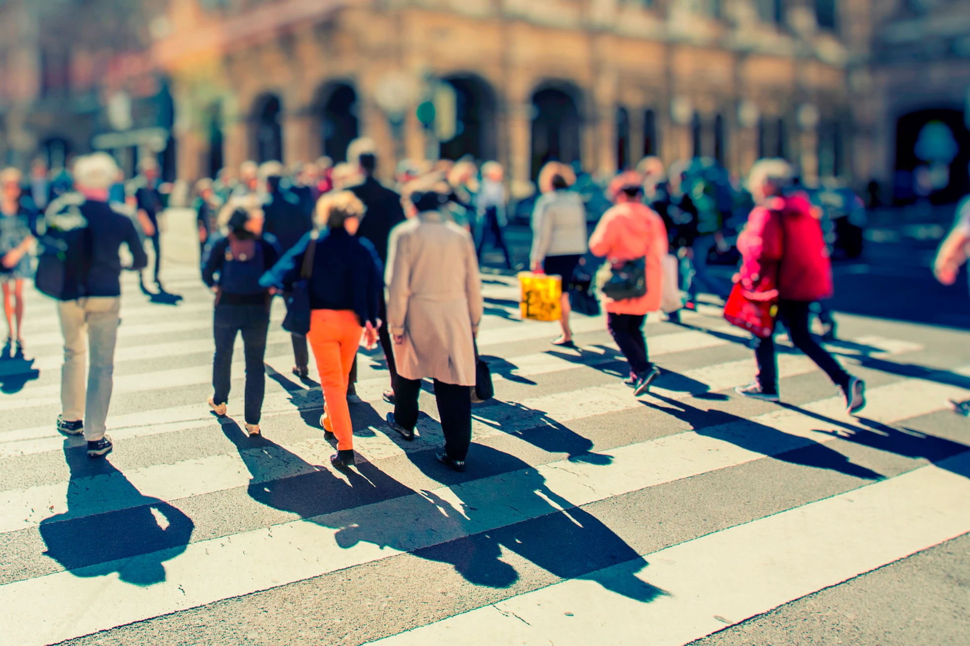 Crowd of anonymous people walking on busy city street