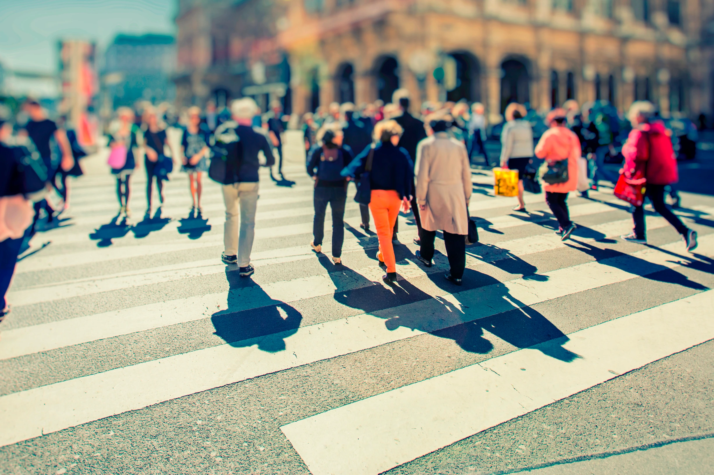 Crowd of anonymous people walking on busy city street