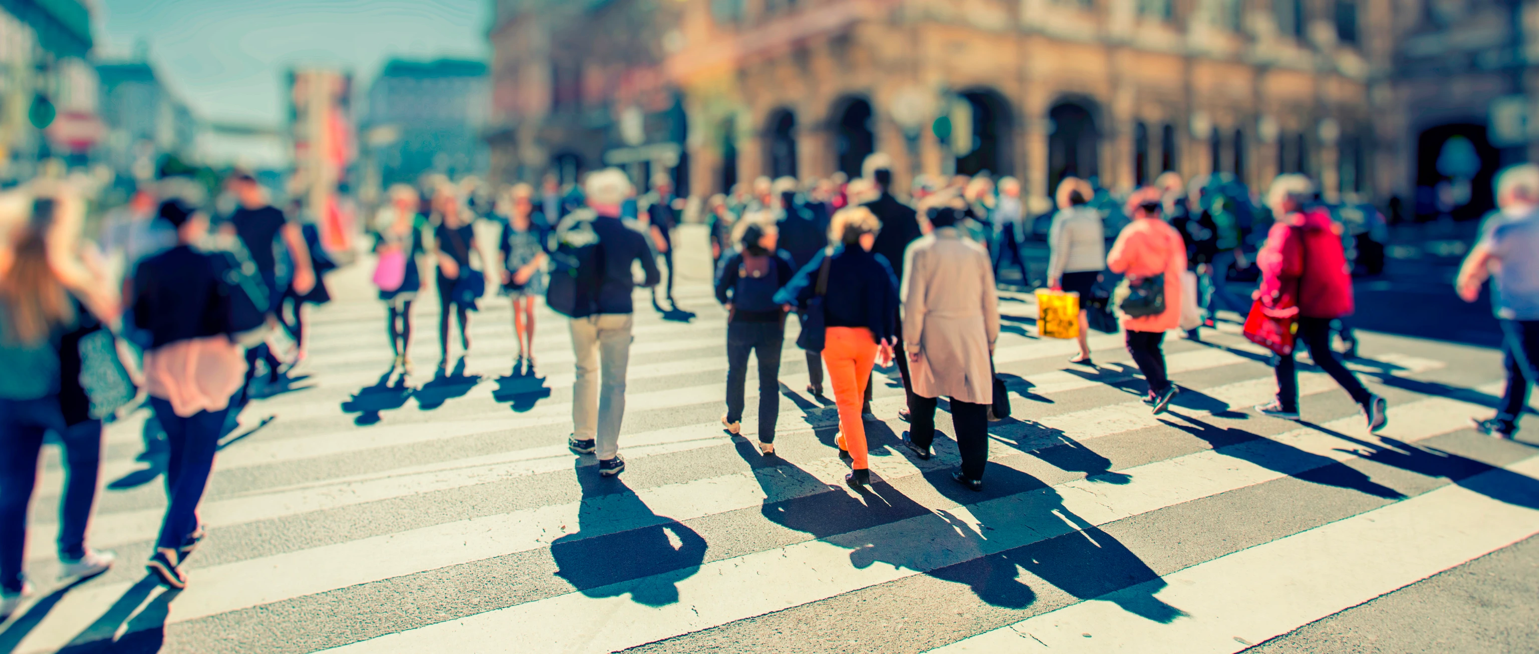 Crowd of anonymous people walking on busy city street