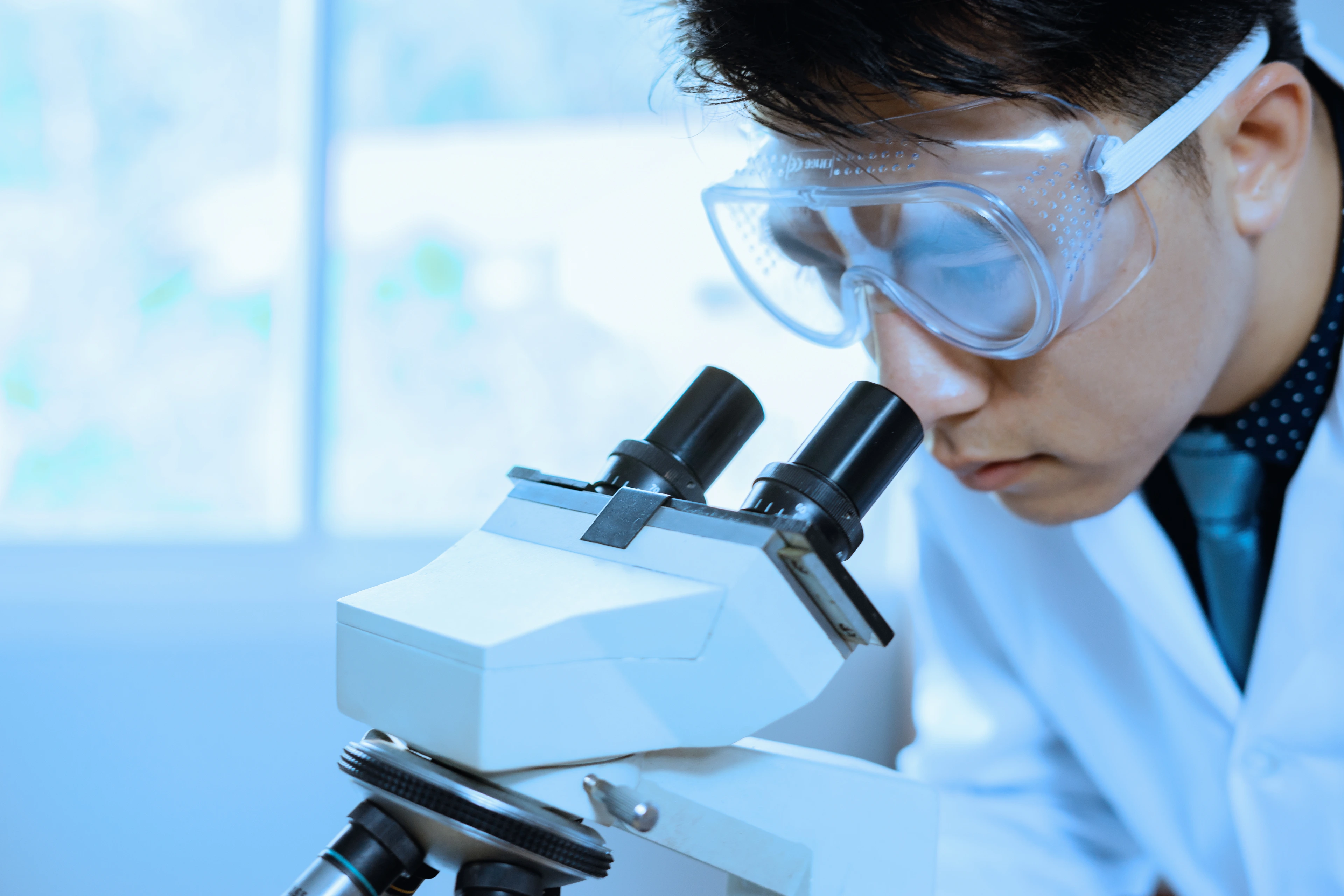 doctor supervisor looking at the microscope slide in the forensic,Laboratory Medical scientists working at lab with test tubes researcher performs liquid
