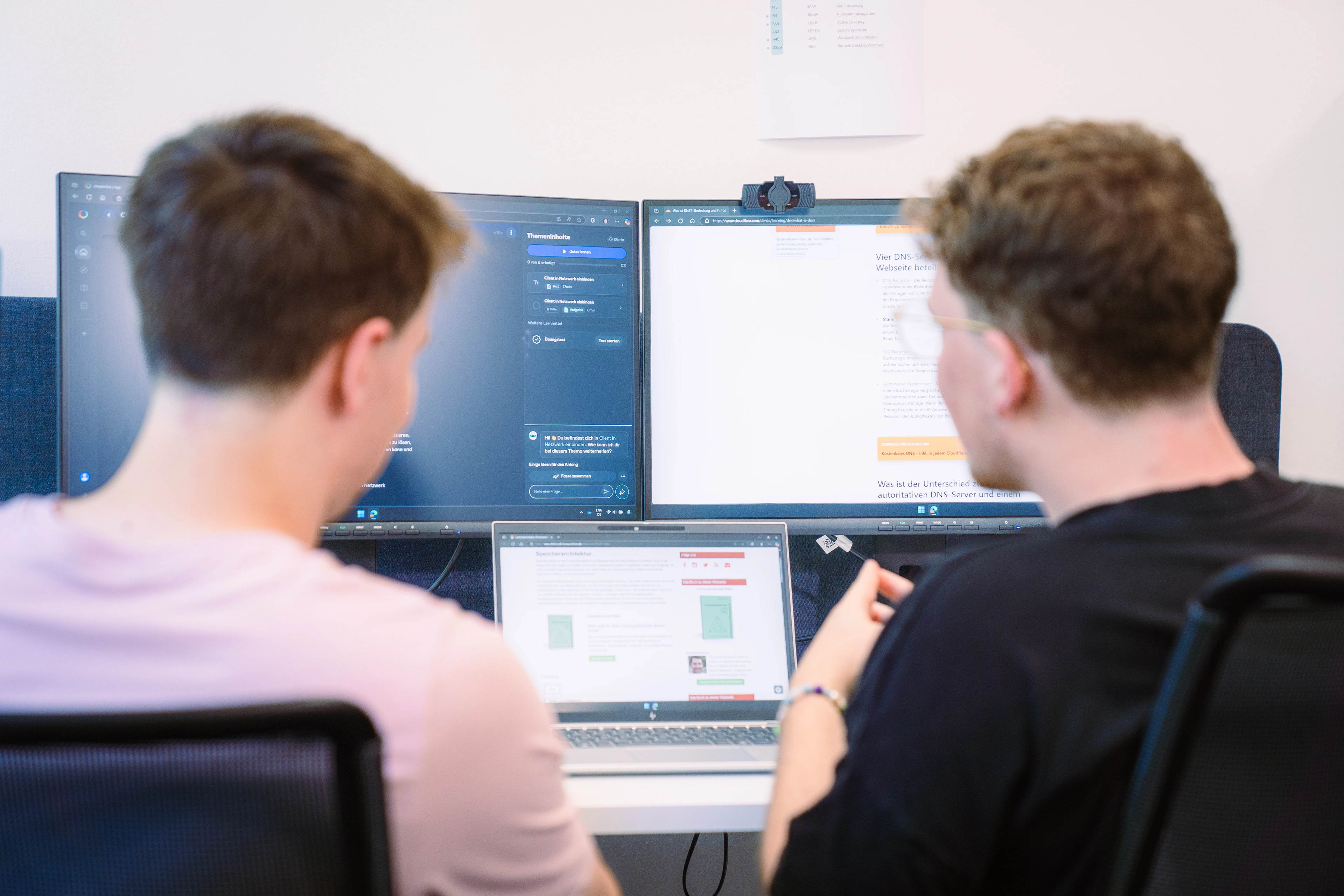 IT specialists sitting in front of a computer