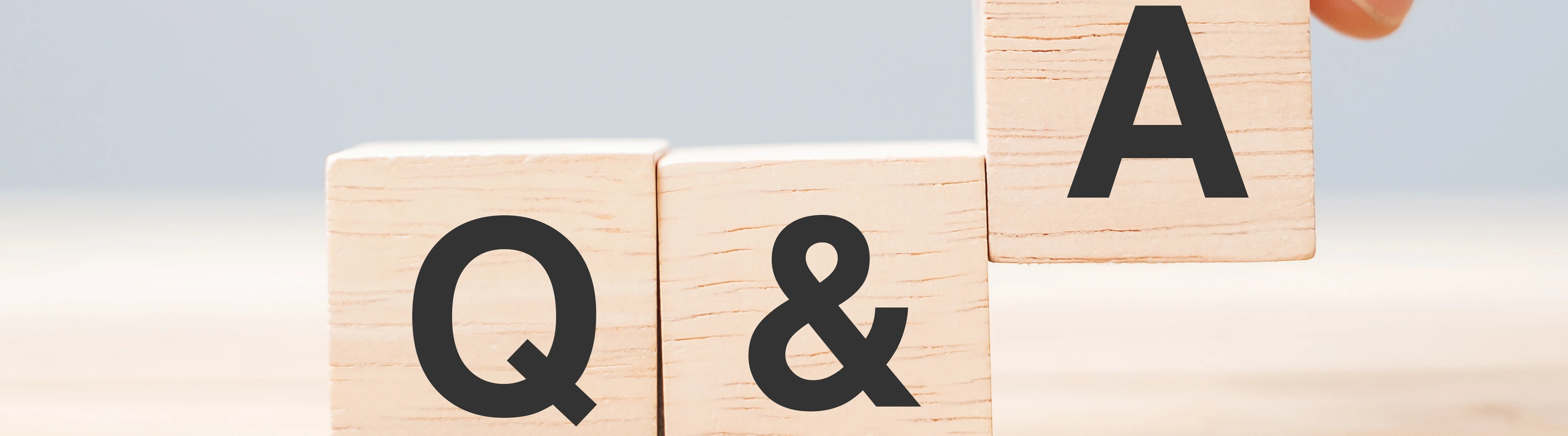 Hand holding Q and A word with wooden cube block. FAQ( frequency asked questions), Answer, Question  Ask, Information, Communication and Brainstorming Concepts