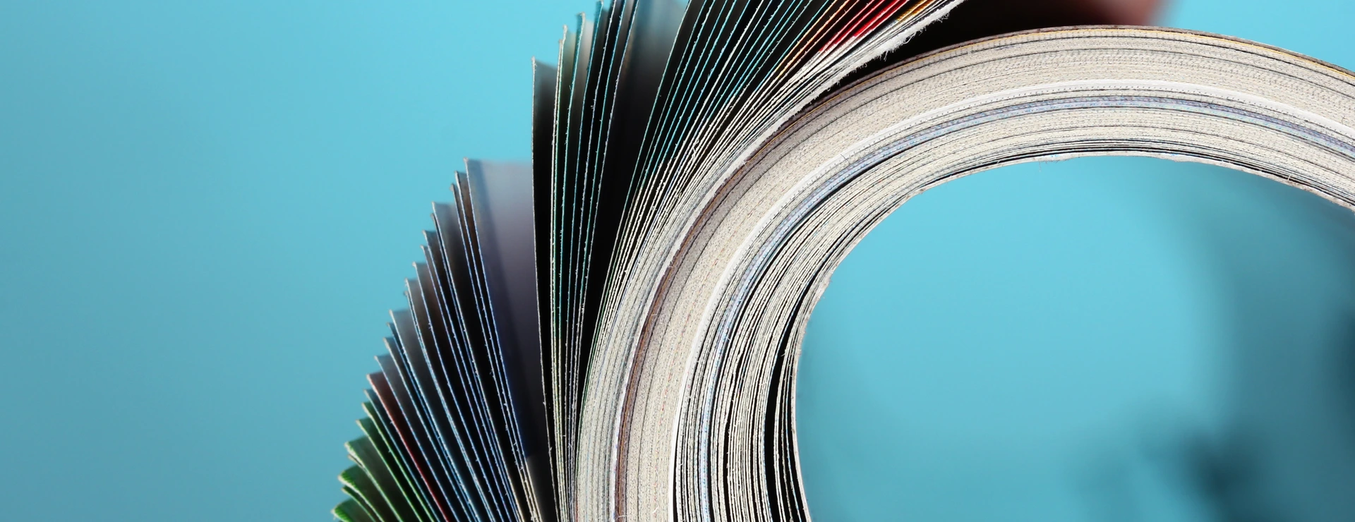 Rolled up magazines on blue background