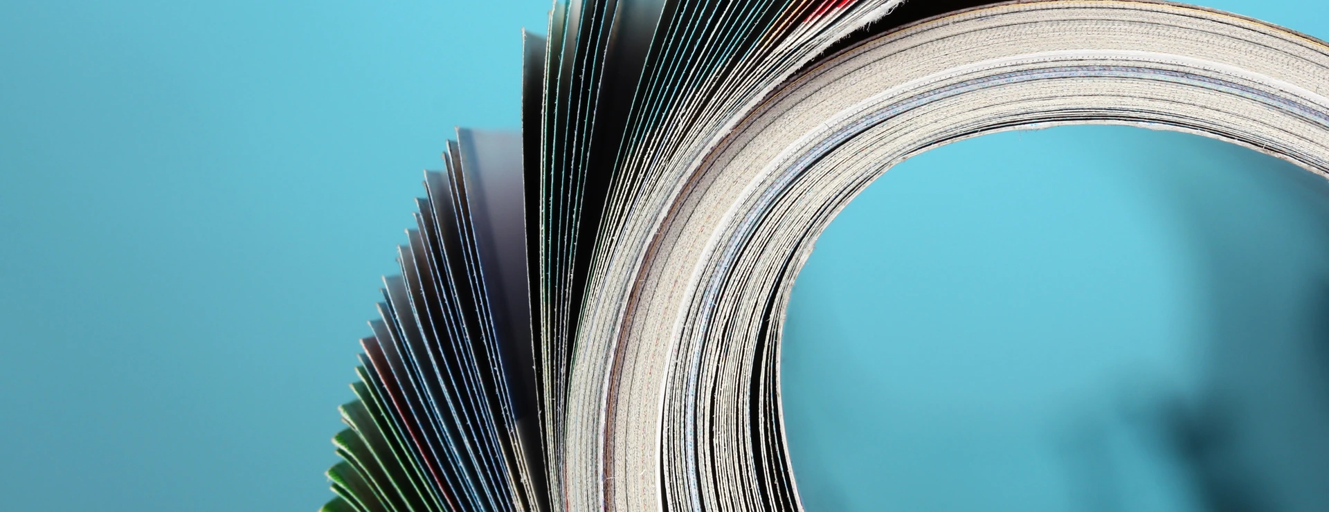 Rolled up magazines on blue background