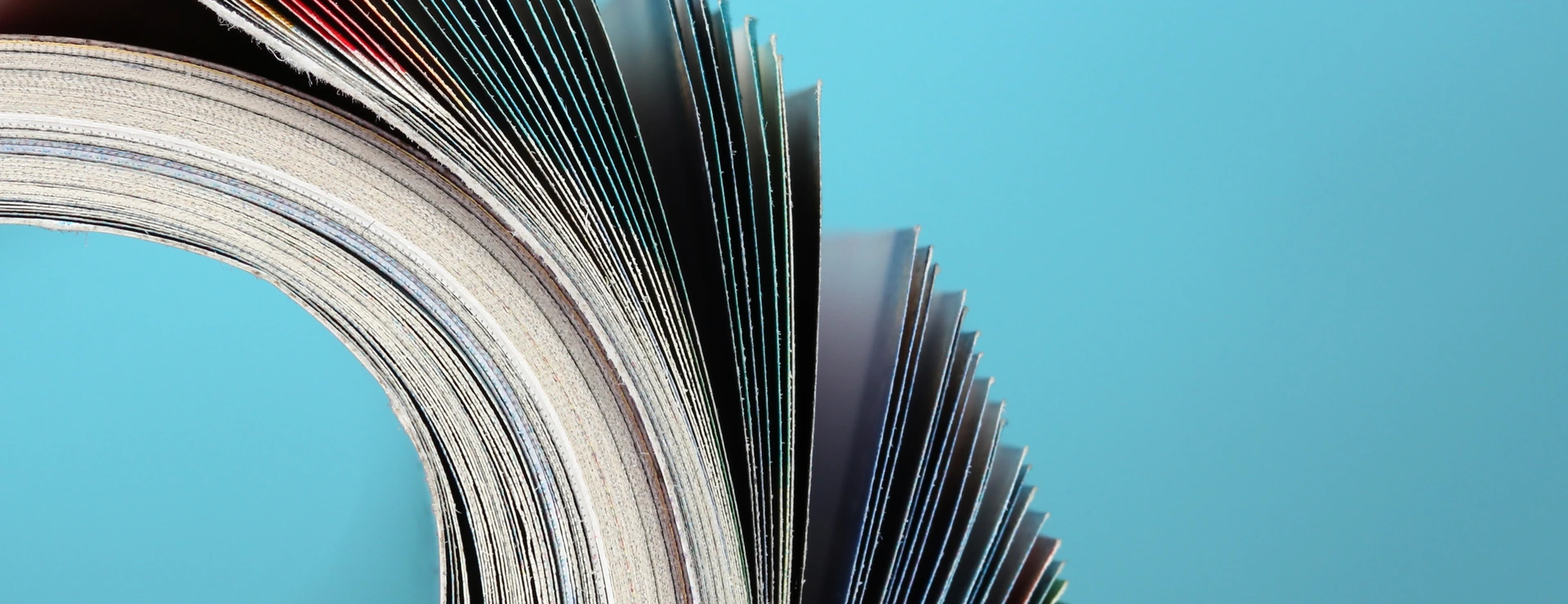 Rolled up magazines on blue background