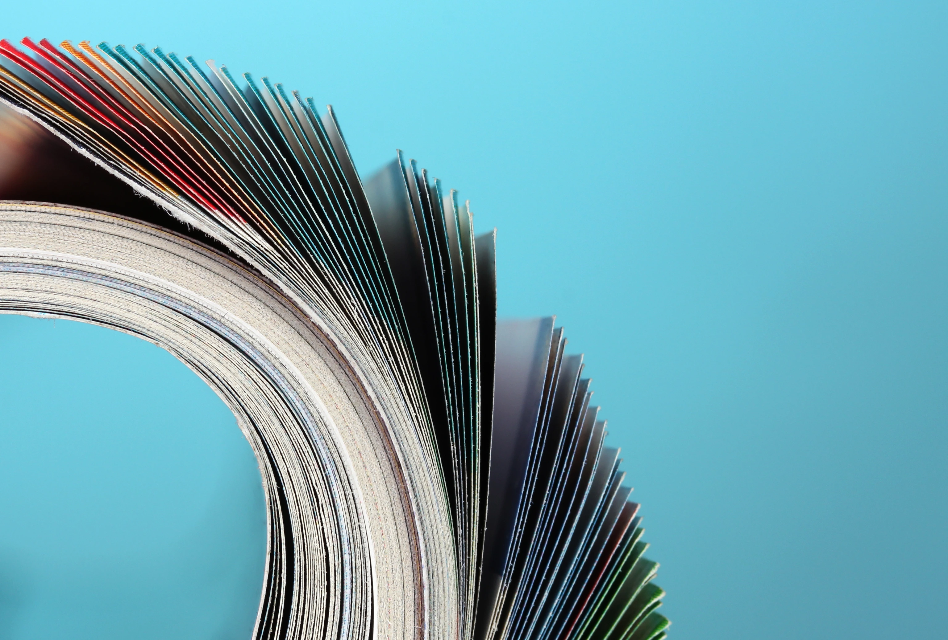 Rolled up magazines on blue background