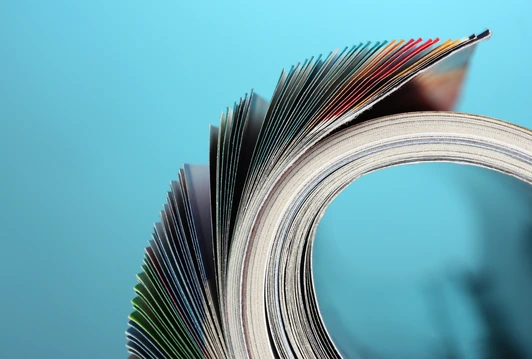 Rolled up magazines on blue background