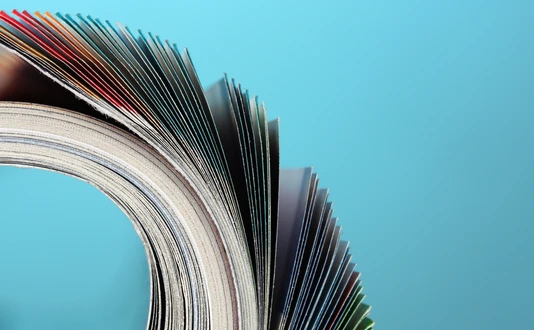 Rolled up magazines on blue background