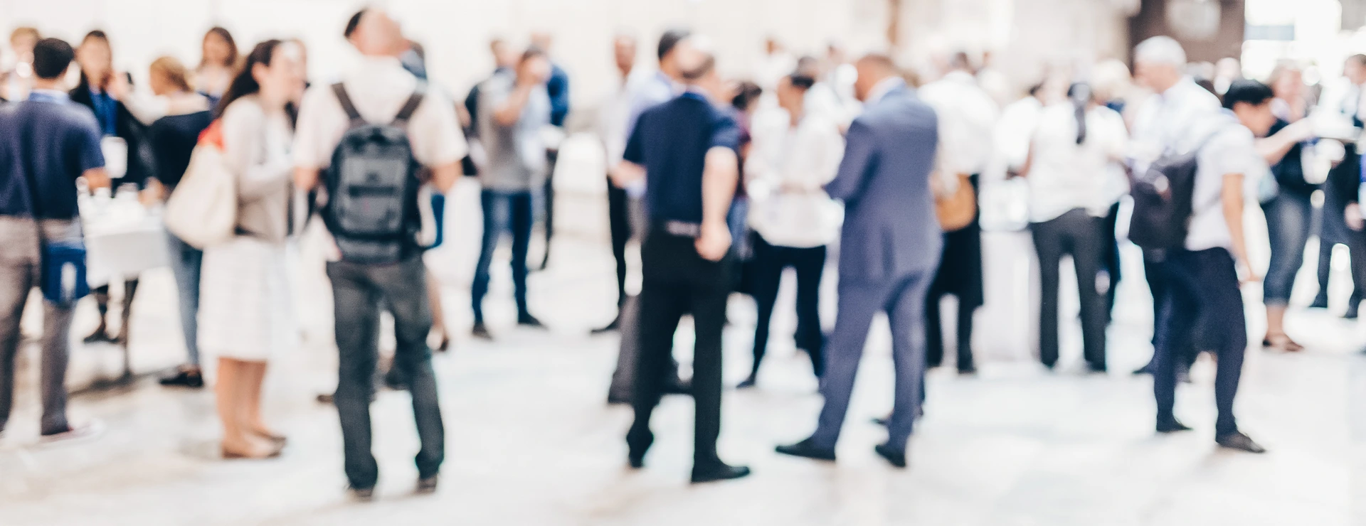 Abstract blurred people socializing during coffee break at business conference.