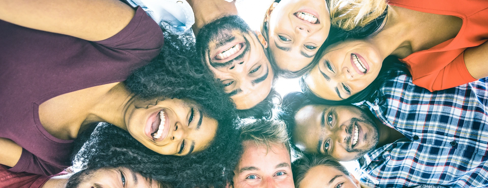 Multiracial best friends millennials taking selfie outdoors with back lighting - Happy youth friendship concept against racism with international young people having fun together - Azure filter tone