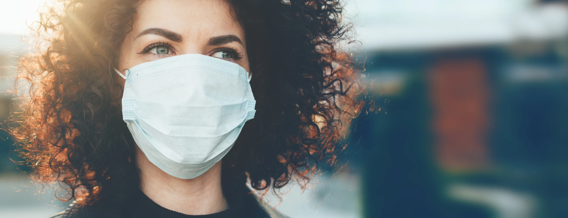 Woman protecting herself from viruses while wearing special mask