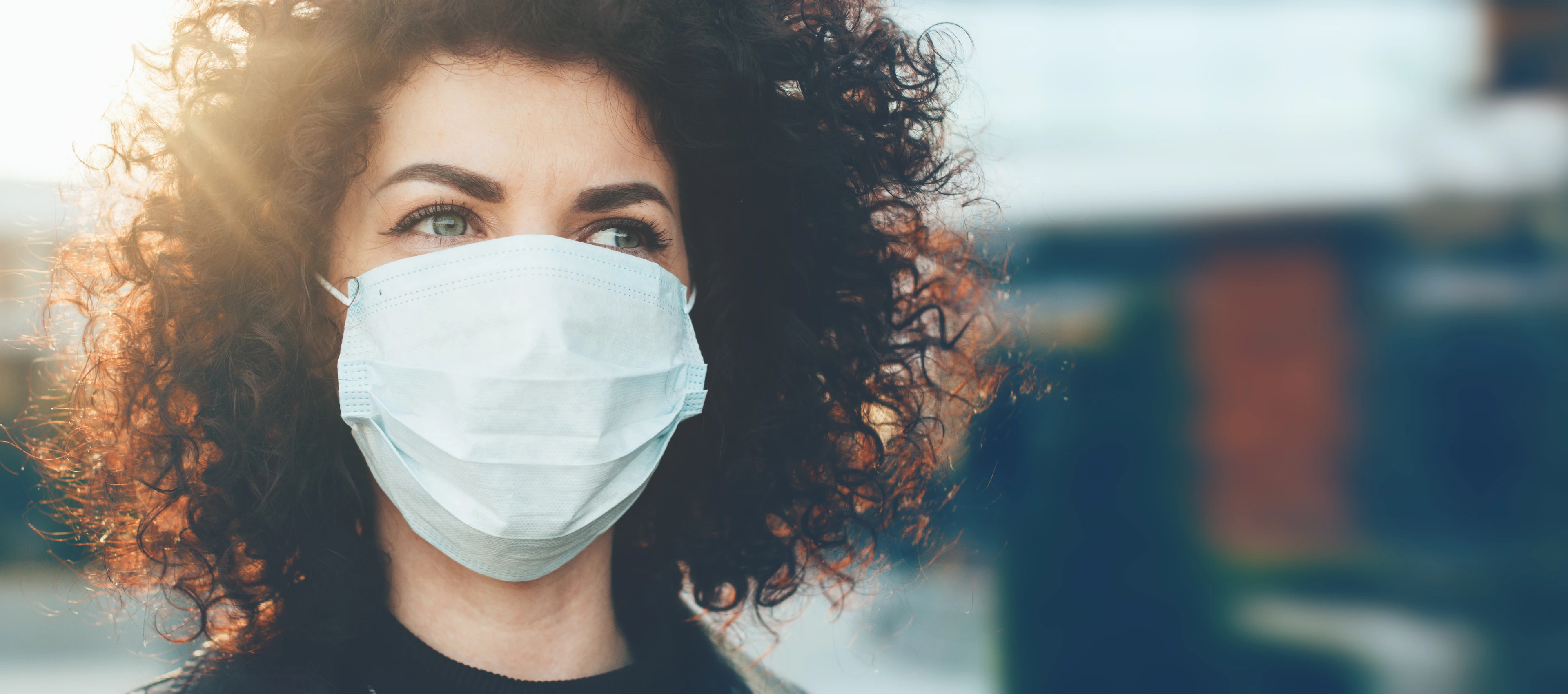 Woman protecting herself from viruses while wearing special mask