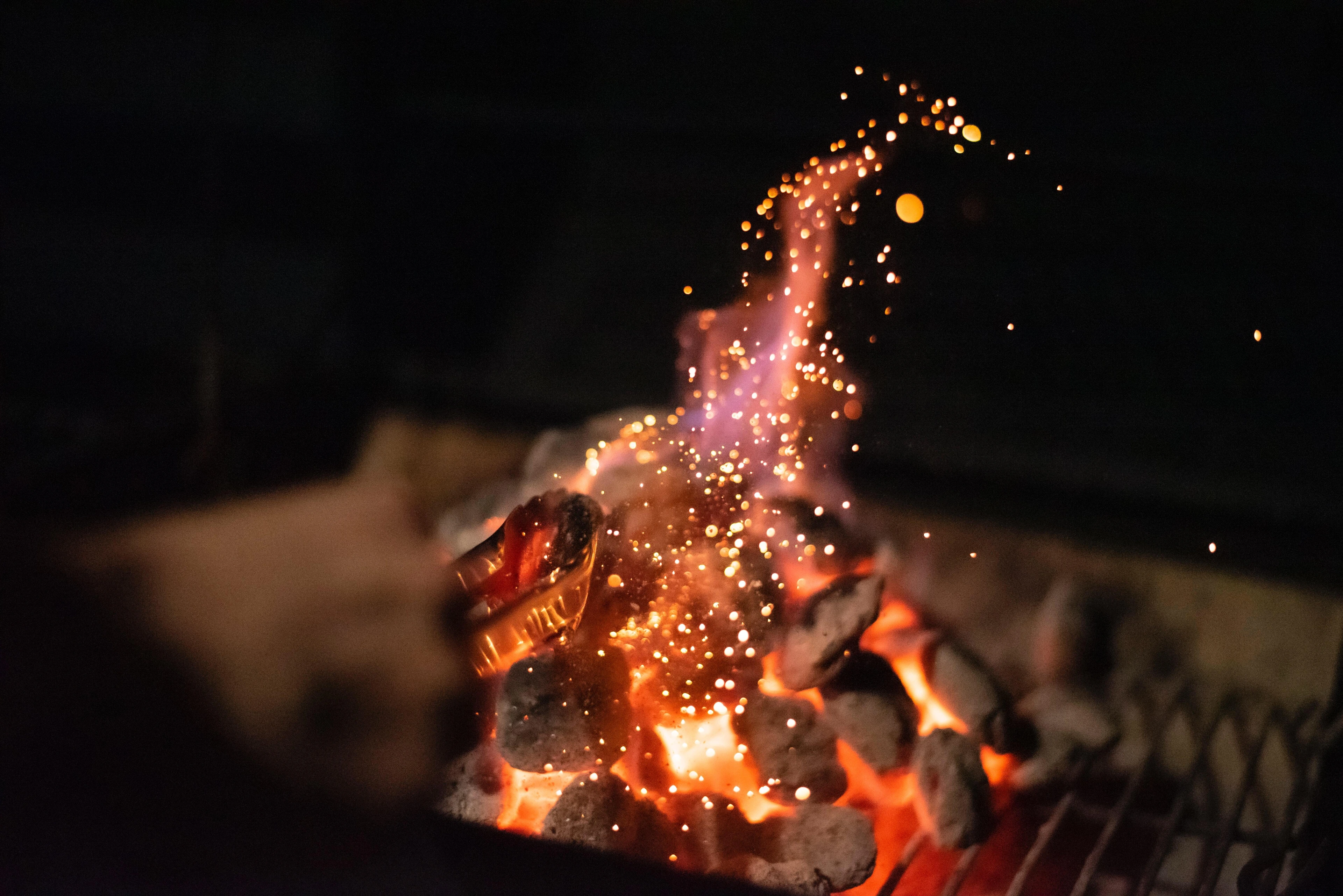 campfire, glowing embers, firelight, night, warmth, flames, outdoor,  flickering light