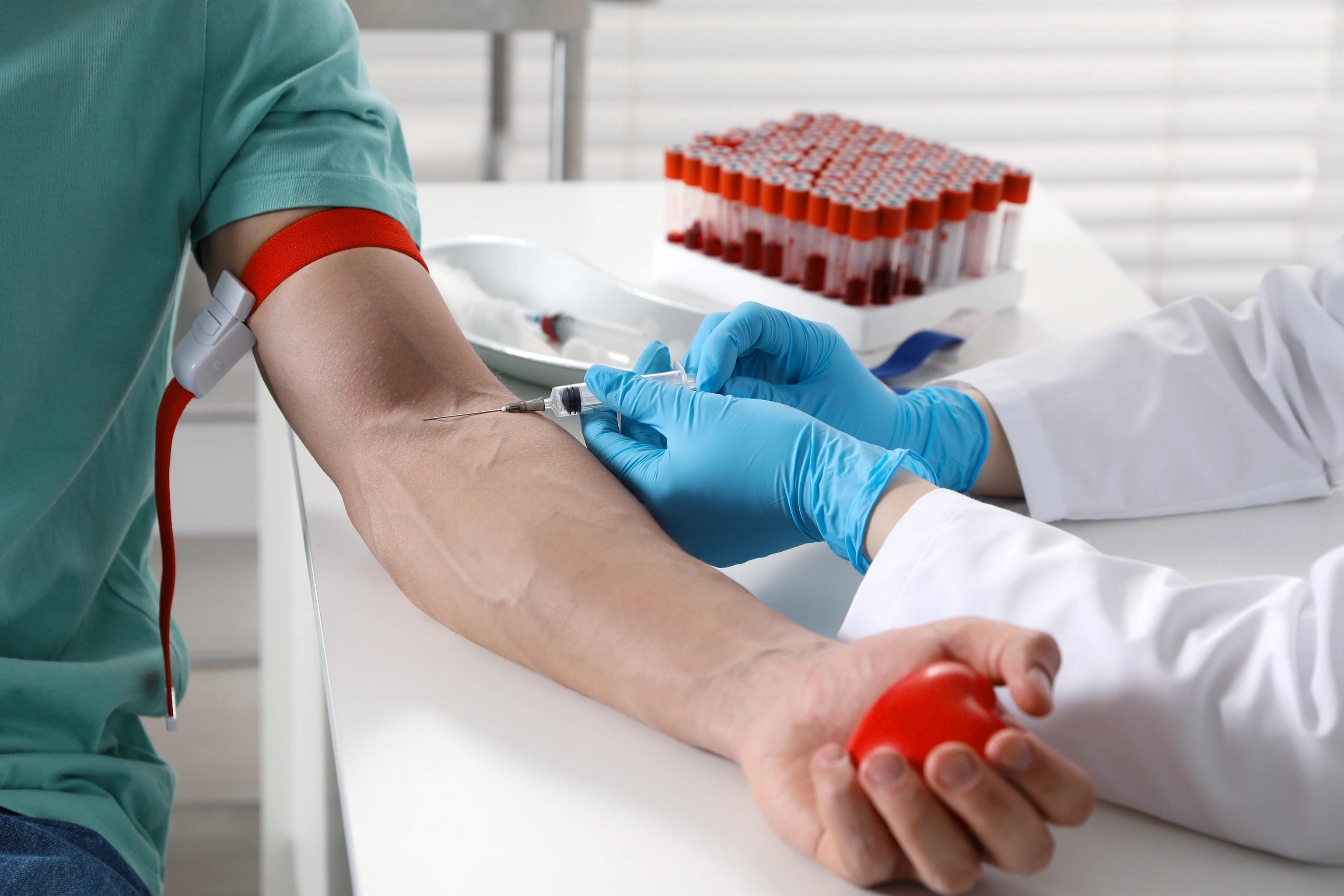 Doctor drawing man's blood sample in clinic, closeup  AdobeStock_1937412501