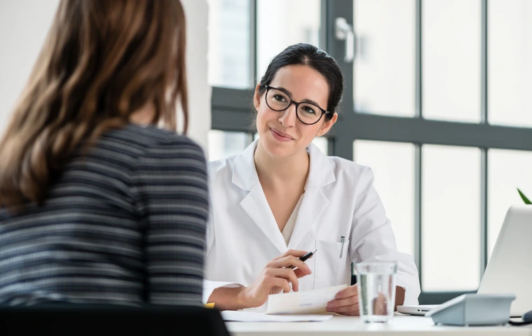Female physician listening to her patient during consultation