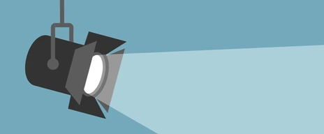 Spotlight shining flat illustration. Movie spotlight on blue background