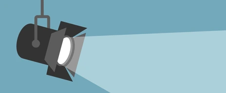 Spotlight shining flat illustration. Movie spotlight on blue background